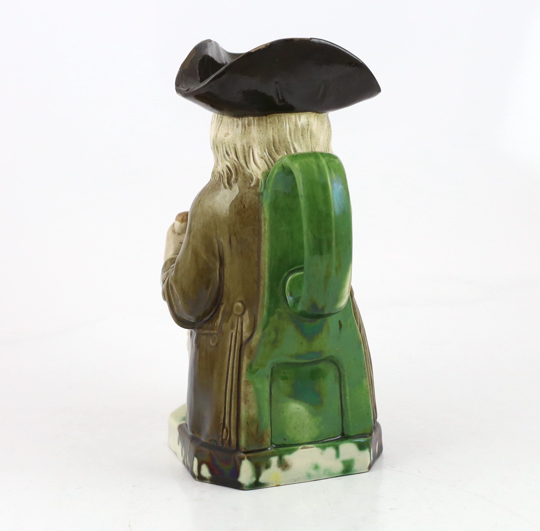 A Ralph Wood type creamware Toby jug of standard type, raising a glass to his lips, c.1790, glaze losses to rim